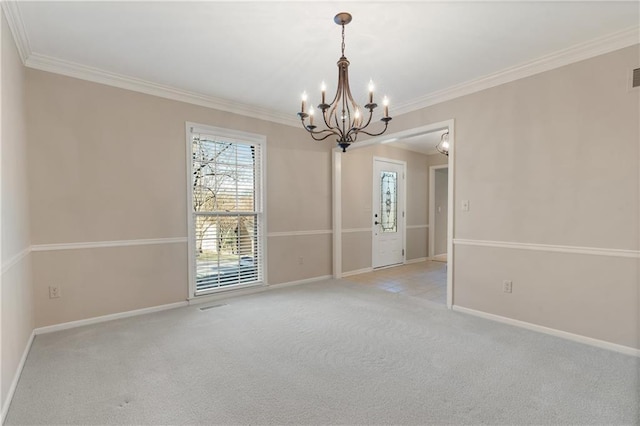 spare room featuring baseboards, carpet floors, a notable chandelier, and crown molding