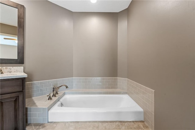 bathroom with vanity, tile patterned floors, and a bath