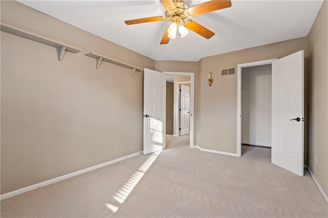 unfurnished bedroom with visible vents, baseboards, light carpet, and ceiling fan