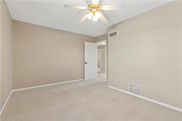 unfurnished room with visible vents, baseboards, light carpet, and ceiling fan