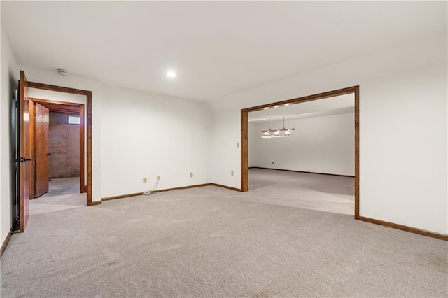 empty room featuring recessed lighting, baseboards, and light colored carpet