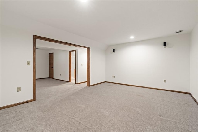 empty room featuring recessed lighting, baseboards, light carpet, and visible vents