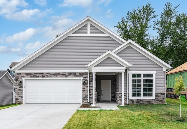 view of front facade with a front lawn, concrete driveway, and stone siding