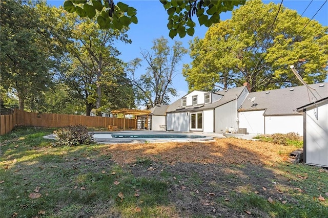 view of yard with french doors, a fenced in pool, and a fenced backyard