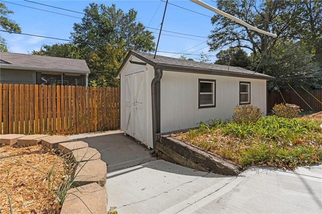 view of outbuilding with an outdoor structure and fence