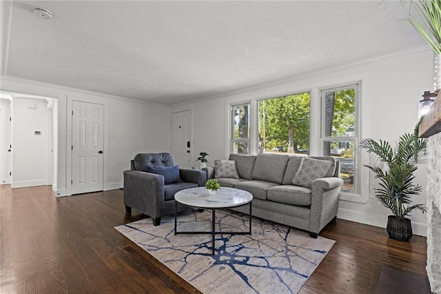 living area featuring crown molding, wood finished floors, and baseboards