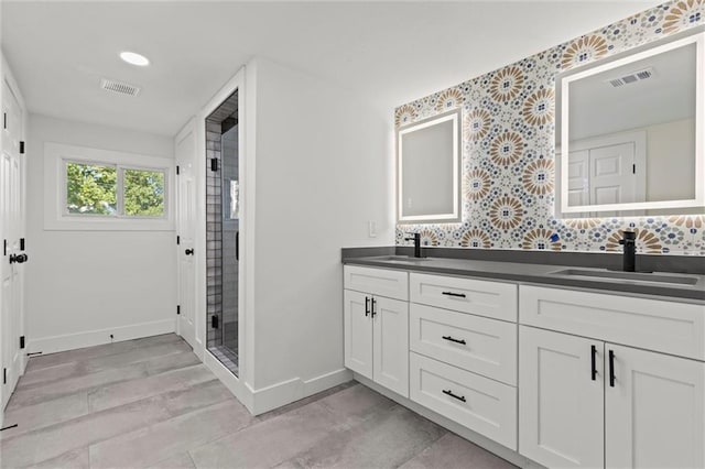 full bathroom with baseboards, visible vents, and a sink