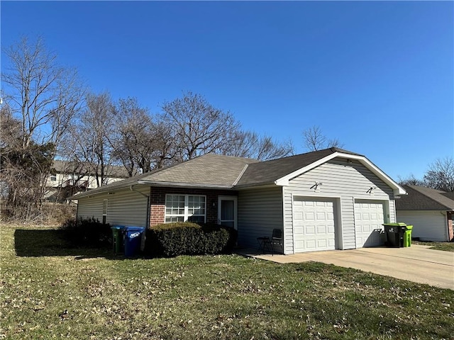 ranch-style home featuring a garage, a front yard, brick siding, and driveway