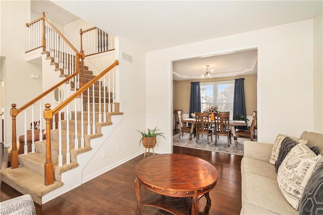 living area with stairway, baseboards, and wood finished floors