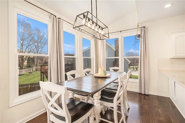 dining area featuring baseboards, recessed lighting, dark wood-type flooring, vaulted ceiling, and a notable chandelier