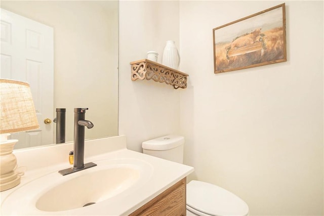 half bathroom with toilet and vanity