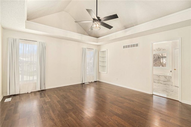 empty room featuring built in features, visible vents, dark wood finished floors, lofted ceiling, and ceiling fan