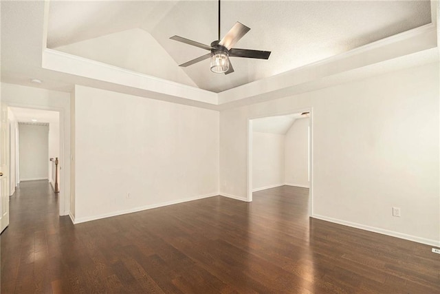 empty room with baseboards, lofted ceiling, wood finished floors, and a ceiling fan