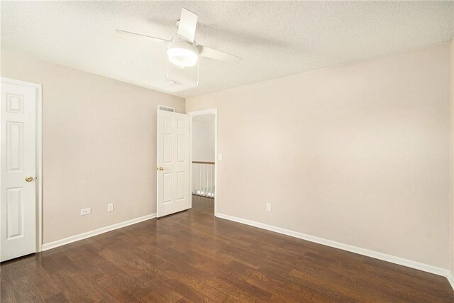 unfurnished bedroom featuring ceiling fan, baseboards, a textured ceiling, and dark wood finished floors