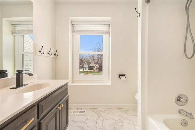 bathroom featuring a wealth of natural light, visible vents, baseboards, and marble finish floor