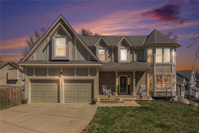 view of front facade with concrete driveway, fence, a front lawn, and stucco siding