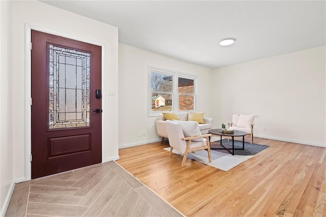 entryway featuring baseboards and light wood-type flooring