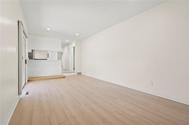 unfurnished living room featuring visible vents, recessed lighting, baseboards, and light wood-type flooring