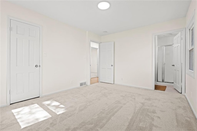 unfurnished bedroom featuring visible vents, baseboards, and carpet floors