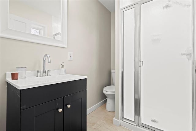 full bath with baseboards, vanity, toilet, and a shower stall