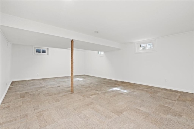 below grade area with baseboards and carpet