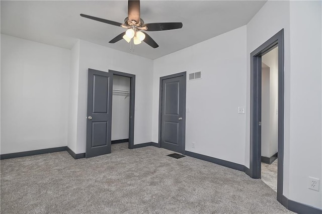 unfurnished bedroom with a ceiling fan, baseboards, visible vents, carpet floors, and a closet