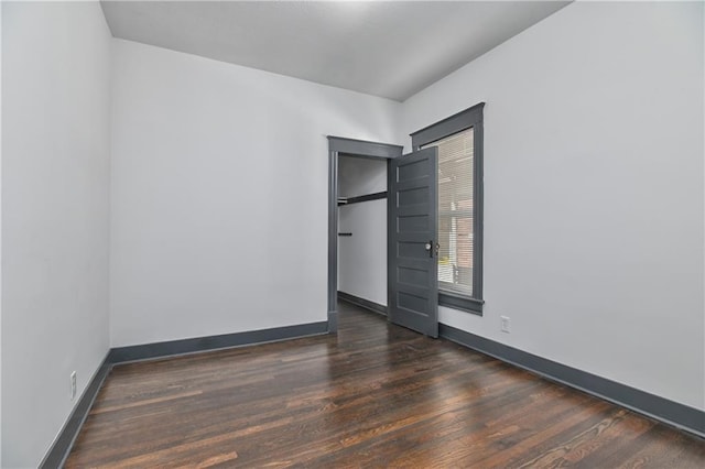 spare room with wood finished floors and baseboards