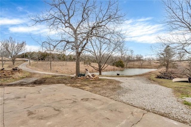 exterior space with gravel driveway and a water view