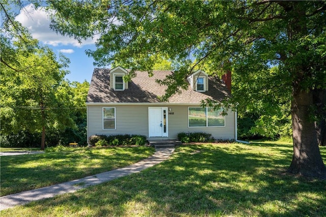 cape cod-style house with roof with shingles and a front lawn