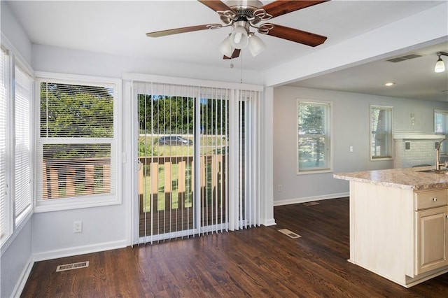 kitchen featuring dark wood finished floors, baseboards, and visible vents