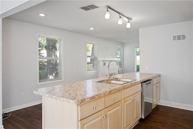 kitchen featuring a sink, visible vents, stainless steel dishwasher, and light brown cabinetry