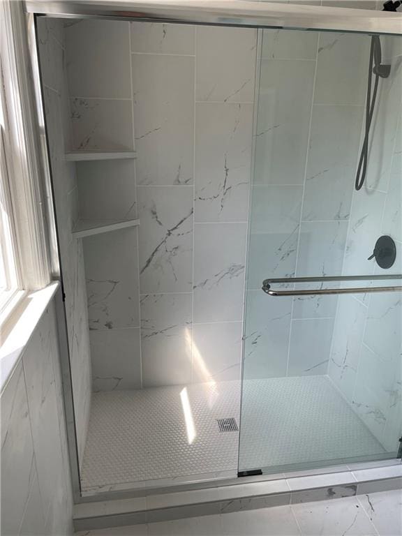 full bath with a shower stall