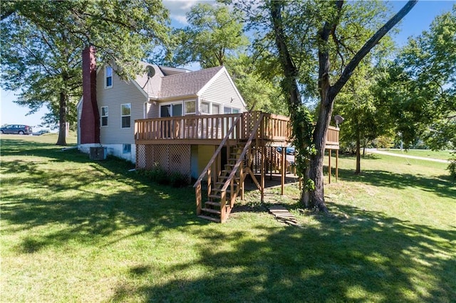 back of house featuring stairway, a lawn, a wooden deck, and a chimney