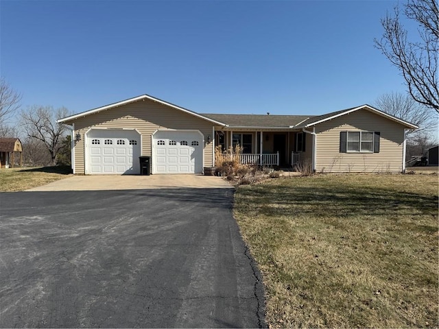 single story home with a front lawn, a garage, covered porch, and driveway