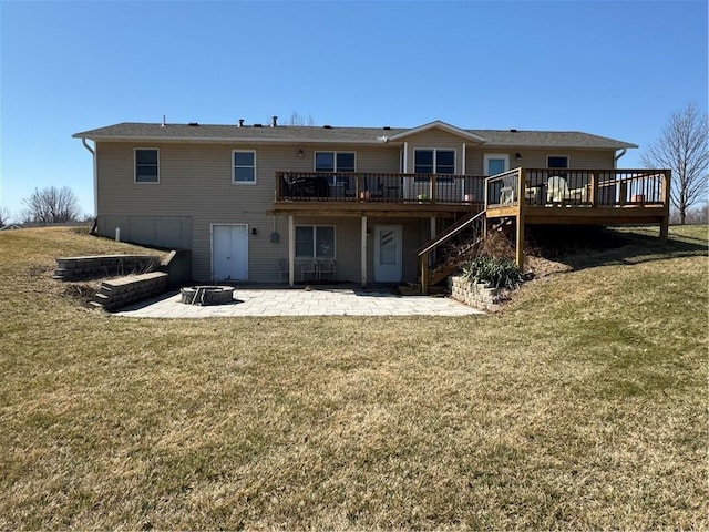 back of property featuring a yard, a fire pit, a deck, and a patio area