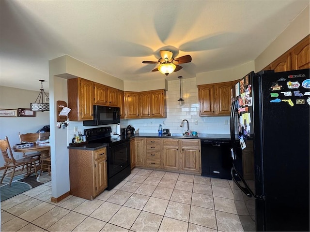 kitchen with brown cabinets, black appliances, and a sink