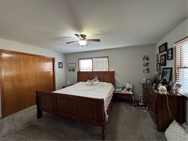 bedroom featuring a ceiling fan and carpet