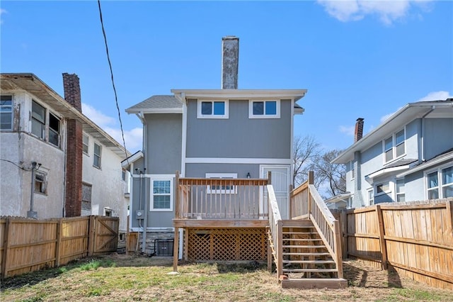 back of house featuring stairway, a fenced backyard, and a wooden deck