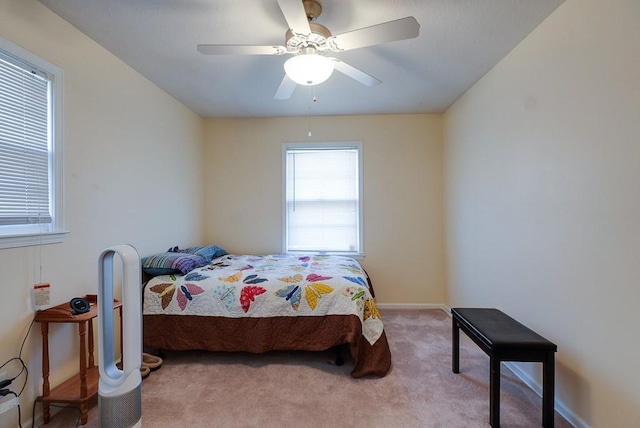 bedroom with baseboards, light colored carpet, and a ceiling fan