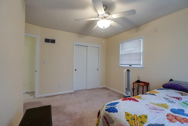 bedroom featuring baseboards, visible vents, ceiling fan, a closet, and carpet flooring