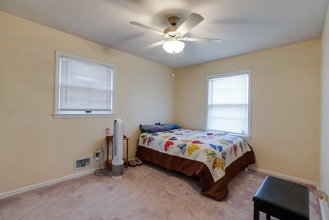 bedroom with a ceiling fan, carpet, visible vents, and baseboards