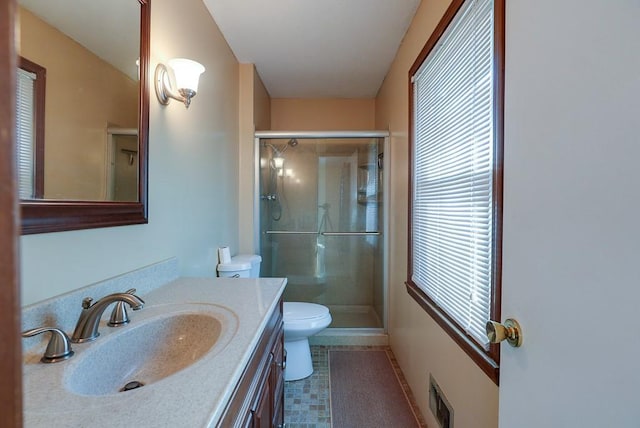 bathroom with visible vents, a shower stall, toilet, and vanity