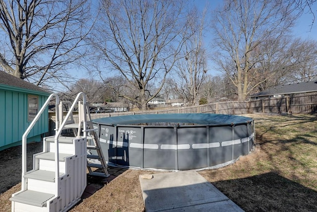 view of swimming pool with a fenced in pool and fence