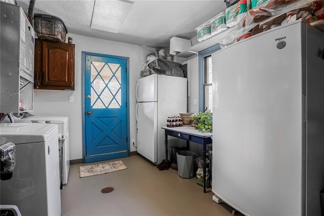 washroom featuring separate washer and dryer, cabinet space, and a textured ceiling