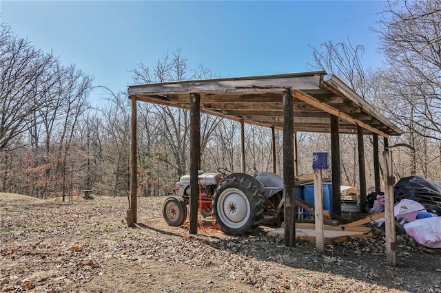 surrounding community with a carport and dirt driveway