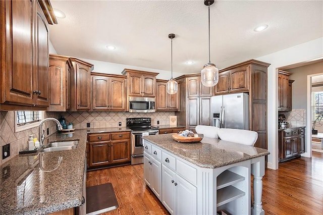 kitchen with open shelves, a sink, stainless steel appliances, dark wood-type flooring, and a center island