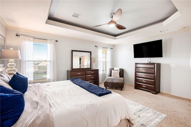 bedroom with visible vents, crown molding, baseboards, carpet, and a raised ceiling