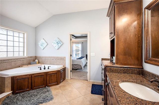 bathroom featuring ensuite bath, lofted ceiling, a bath, tile patterned floors, and vanity