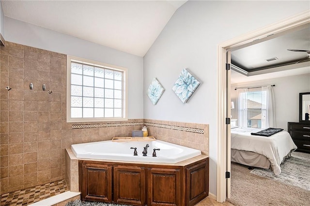 ensuite bathroom featuring visible vents, a garden tub, ensuite bathroom, a tile shower, and lofted ceiling