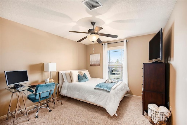 bedroom with visible vents, ceiling fan, baseboards, carpet floors, and a textured ceiling